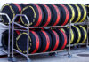 Rows of Formula 1 tyres in tyre blankets stacked in a trolley